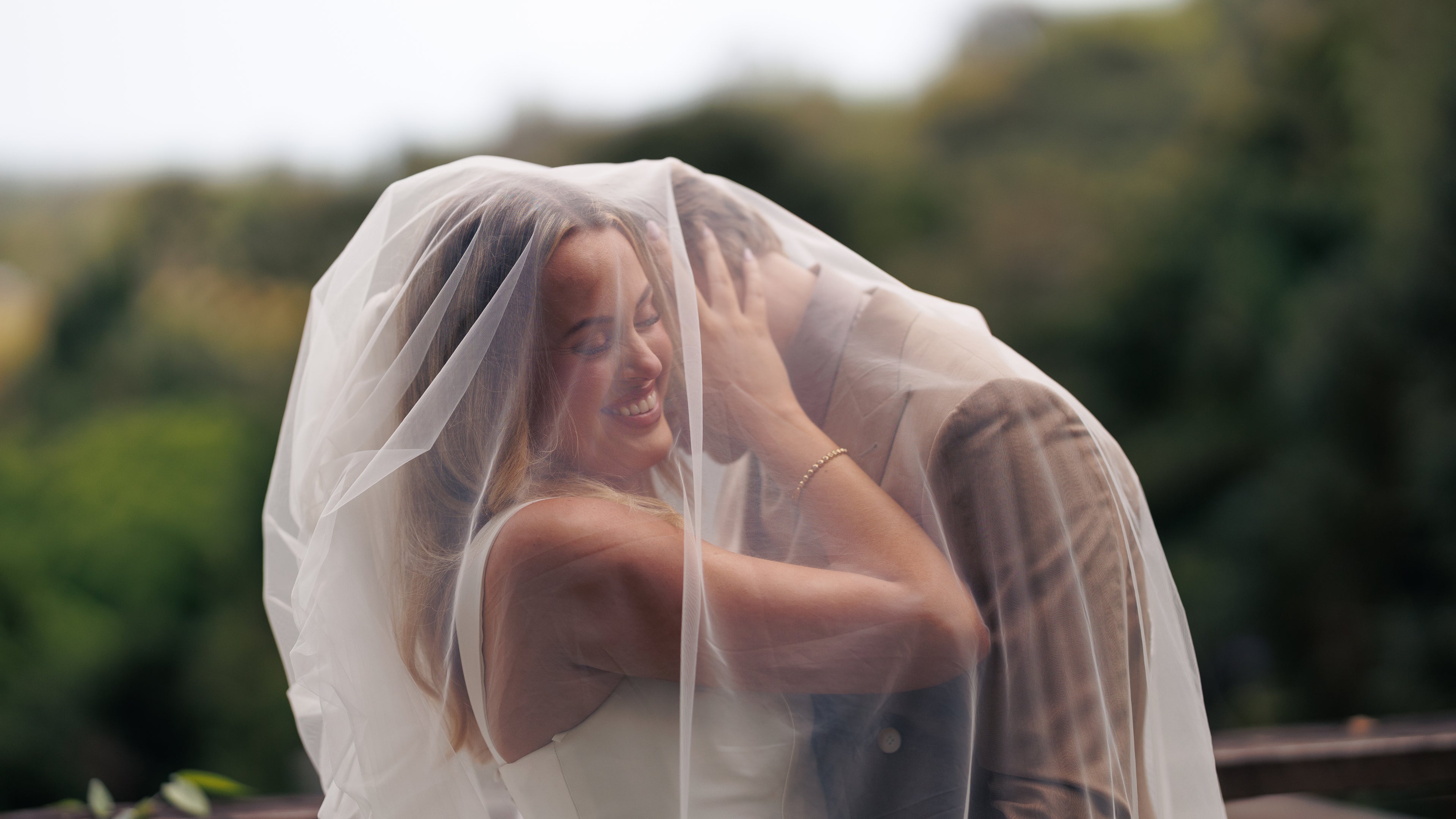 Woman with a veil over her head in a natural setting