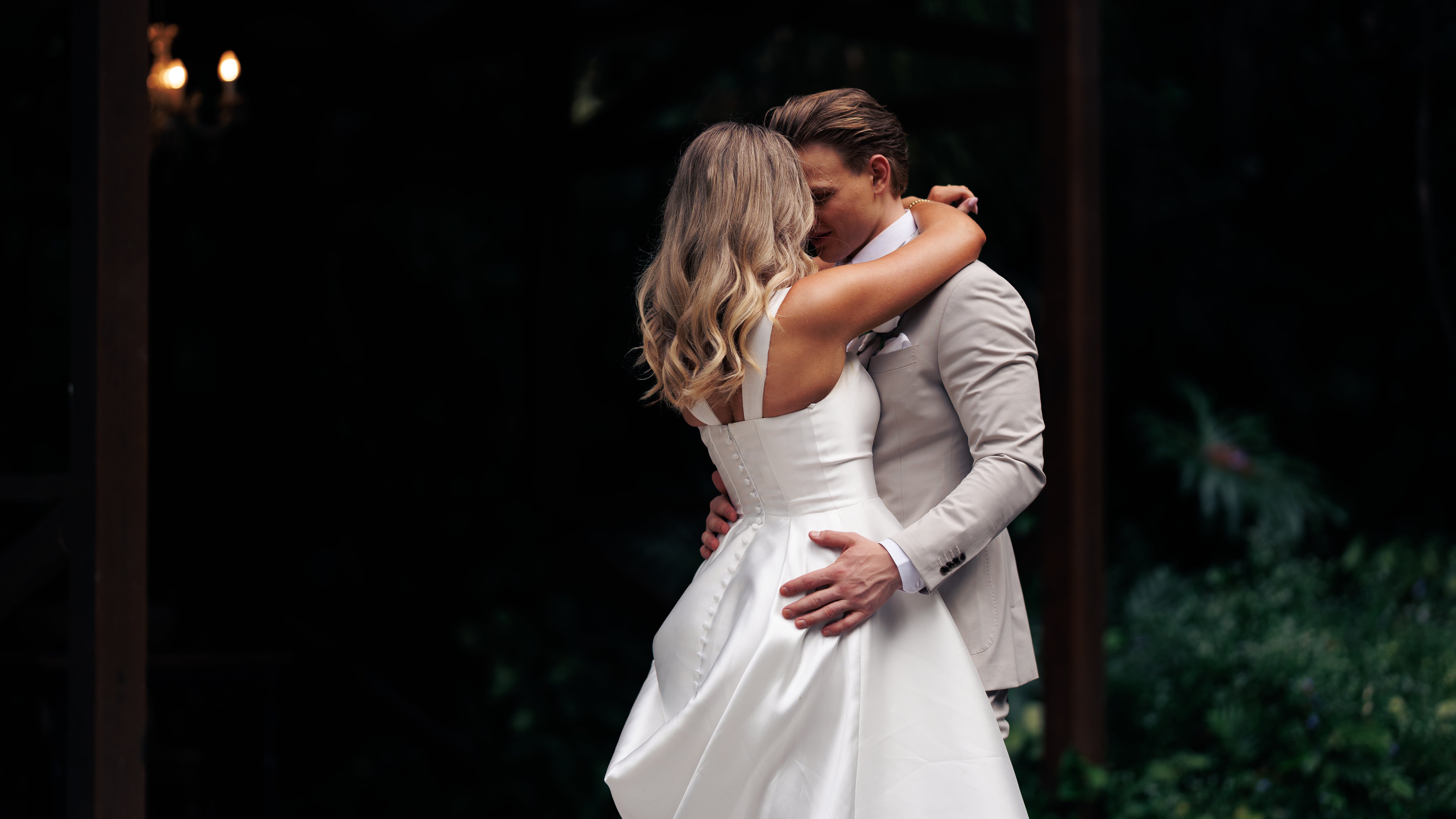 Couple embracing in a dark outdoor setting