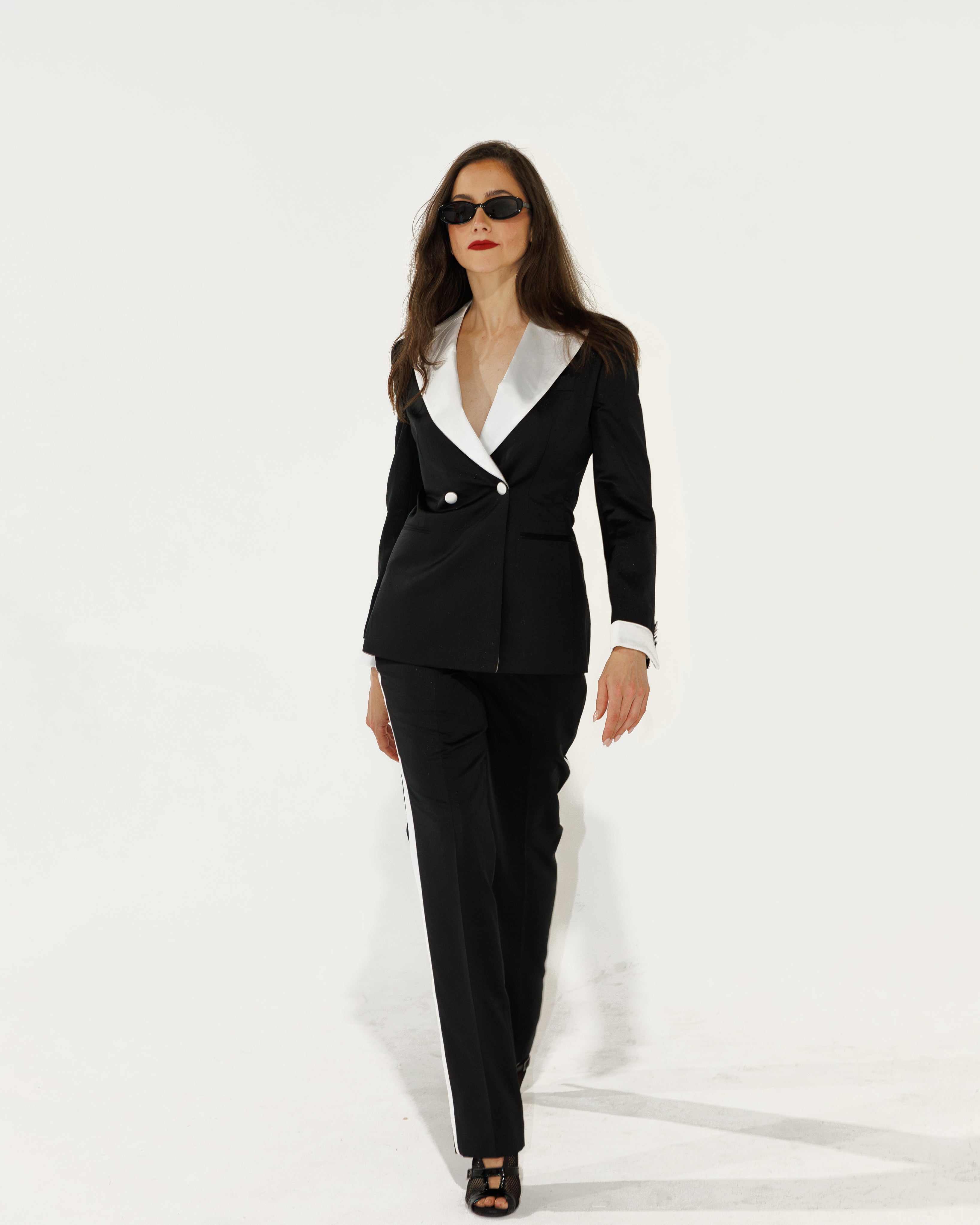 Woman wearing a black and white suit on a white background