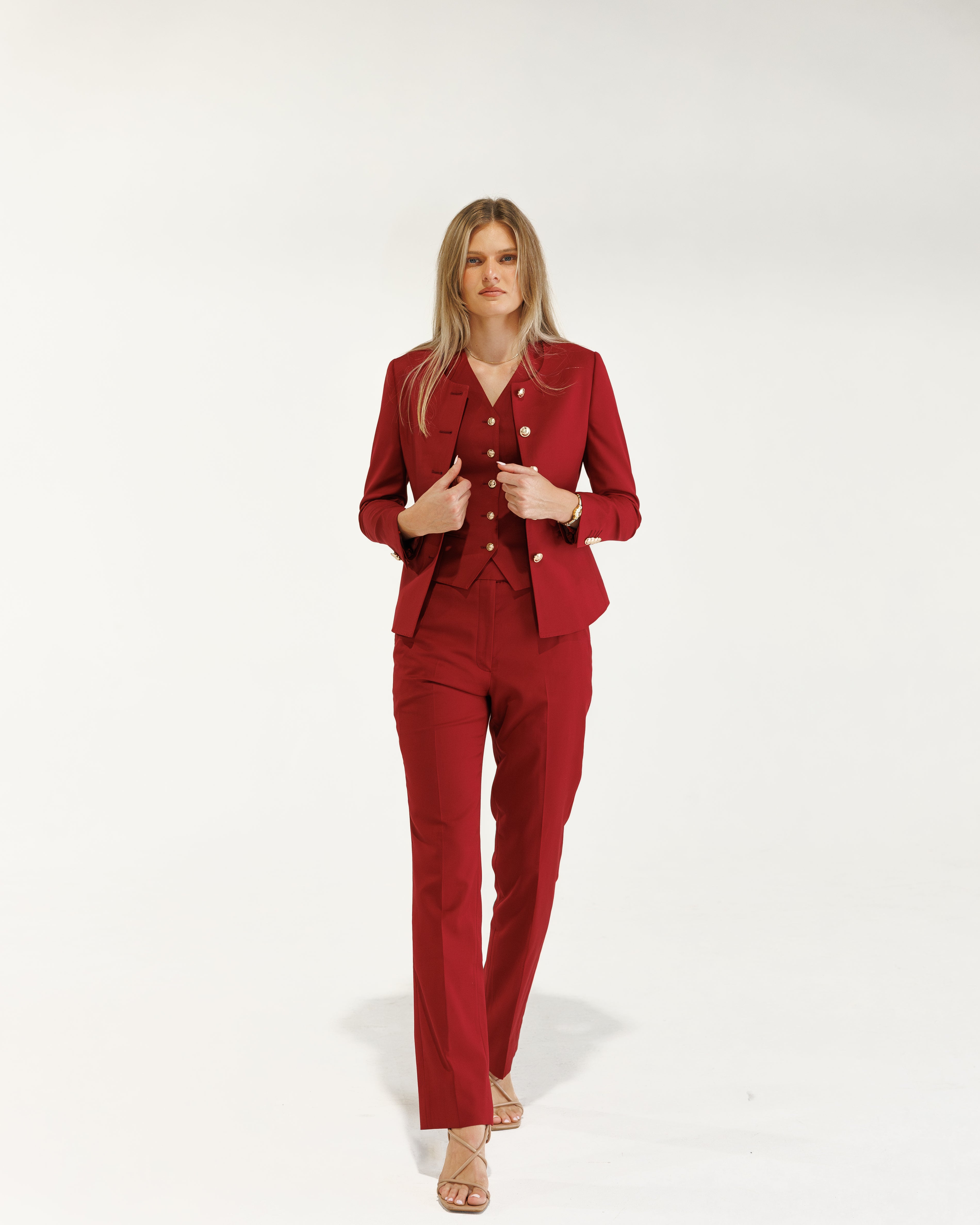 Woman wearing a red suit on a white background