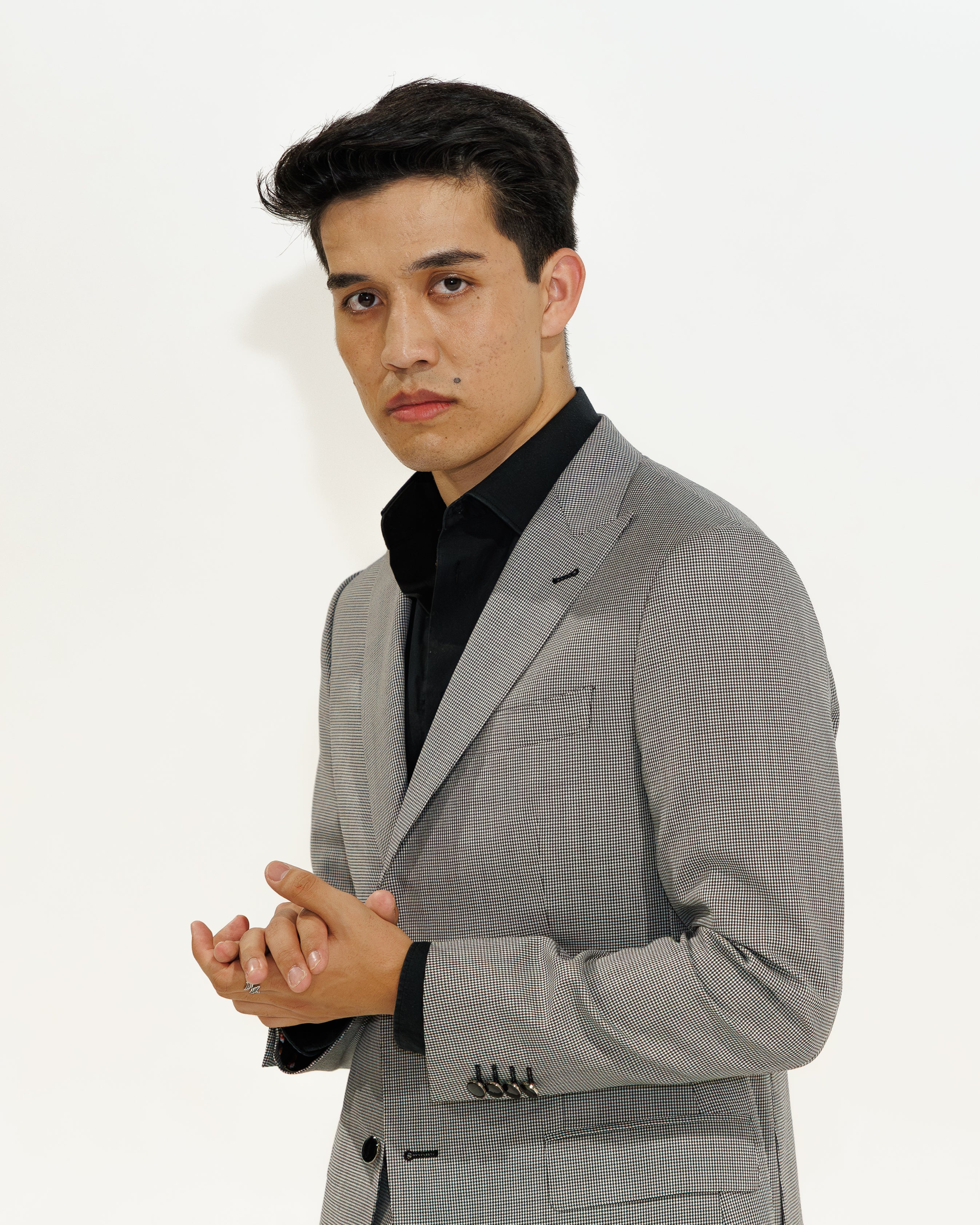 Man wearing a gray suit with a white background