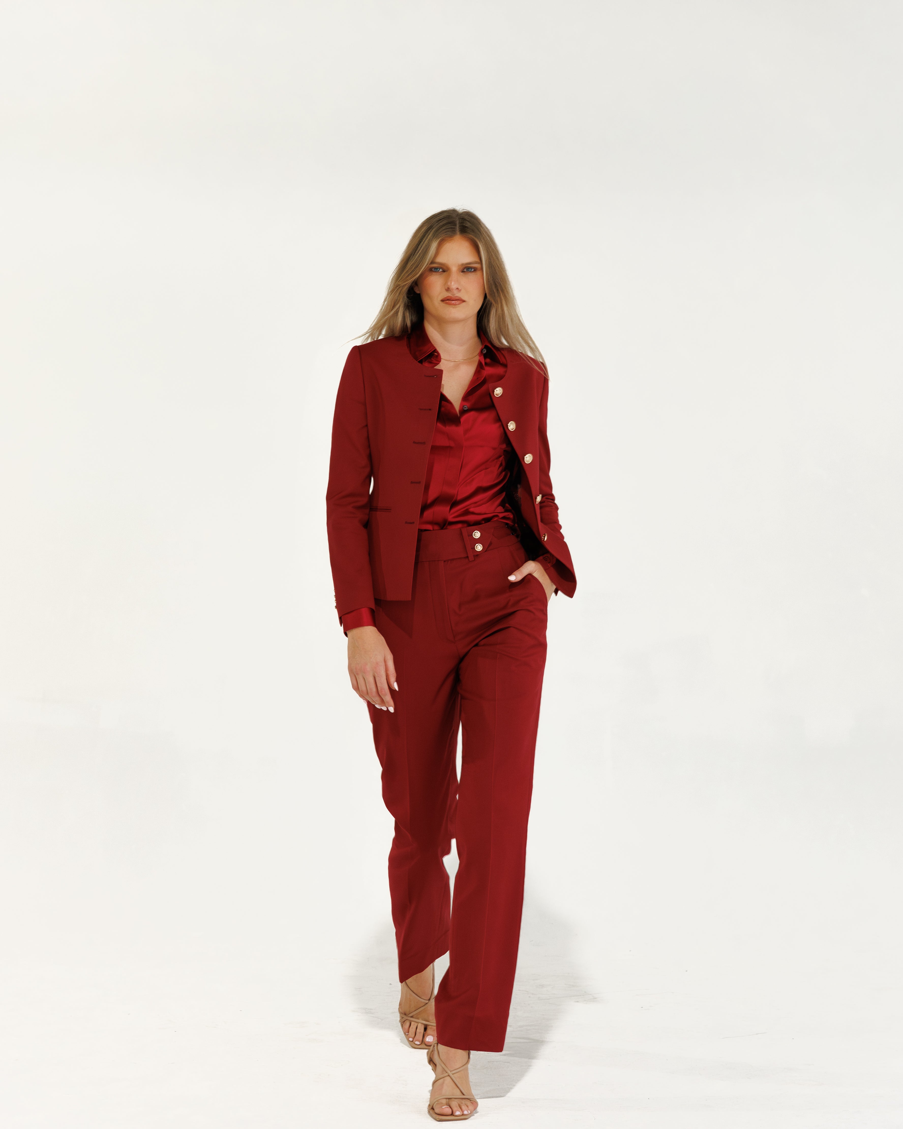 Woman wearing a red suit on a white background