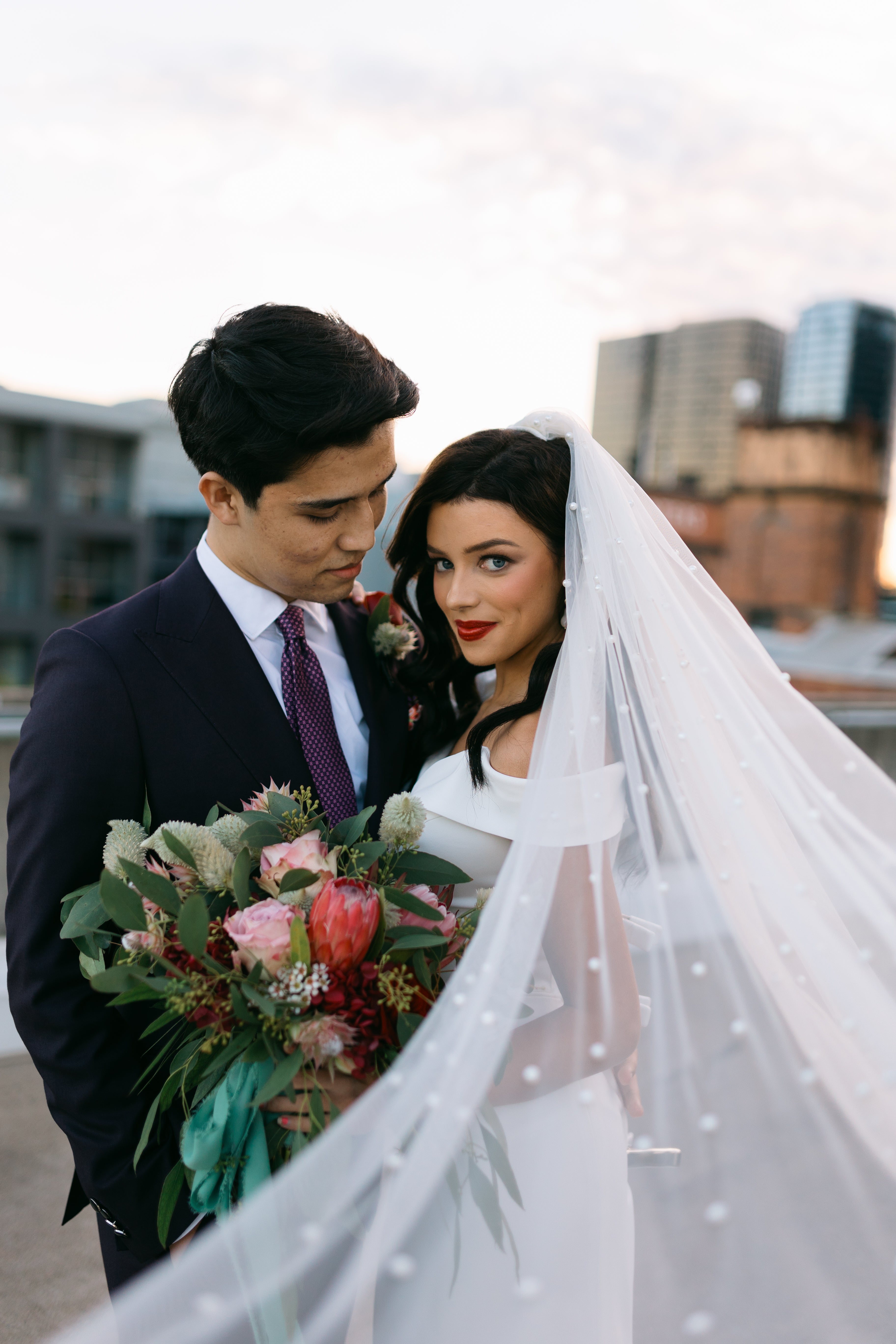 Couple on a rooftop with a cityscape background