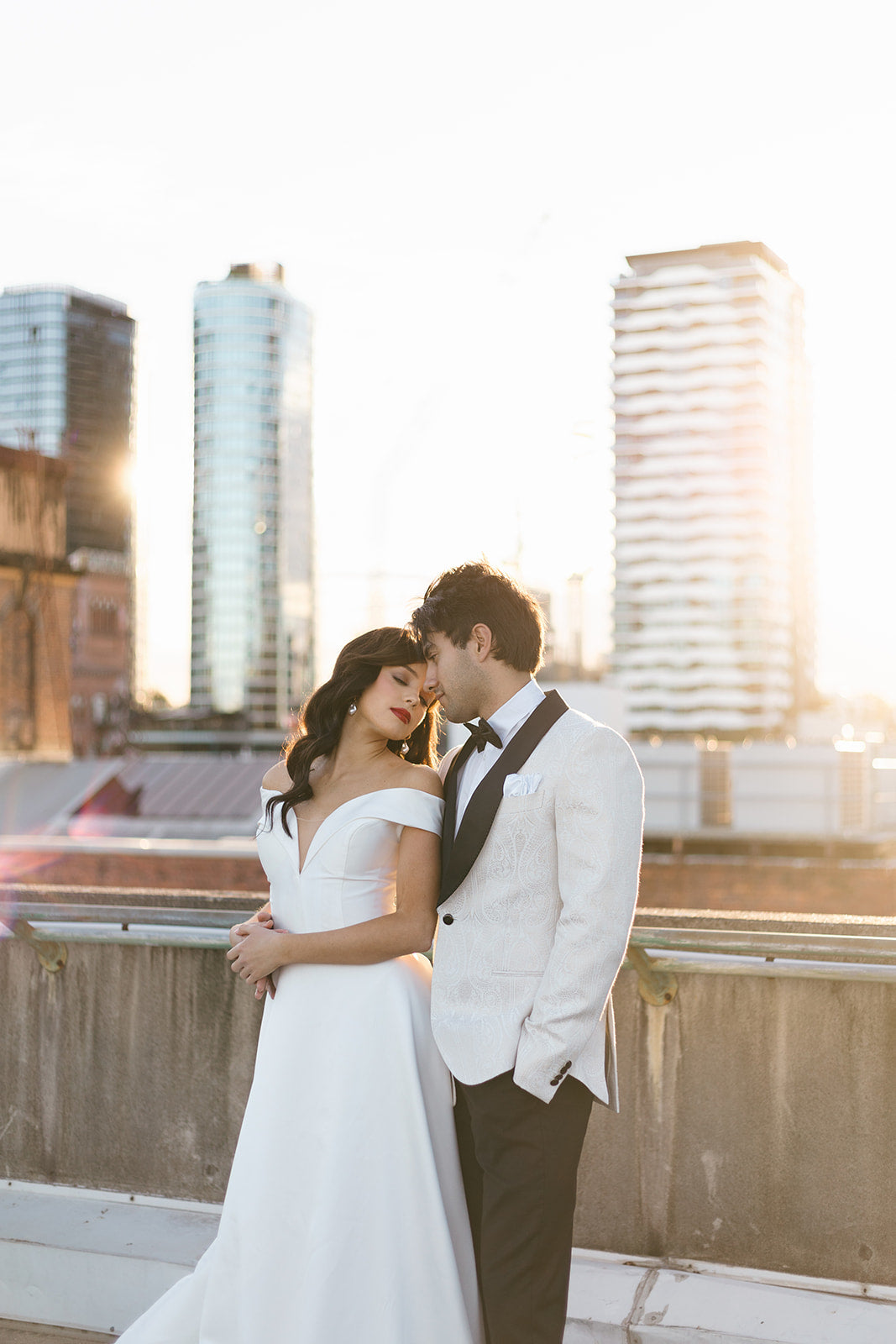 Couple on a rooftop with city skyline in the background