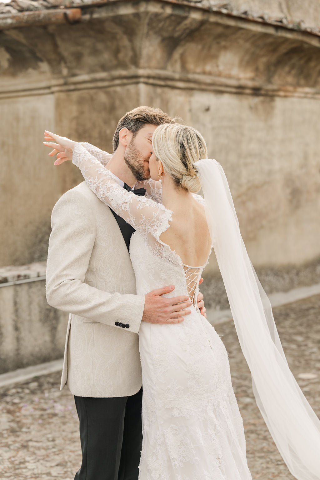 Couple embracing in front of an old stone building